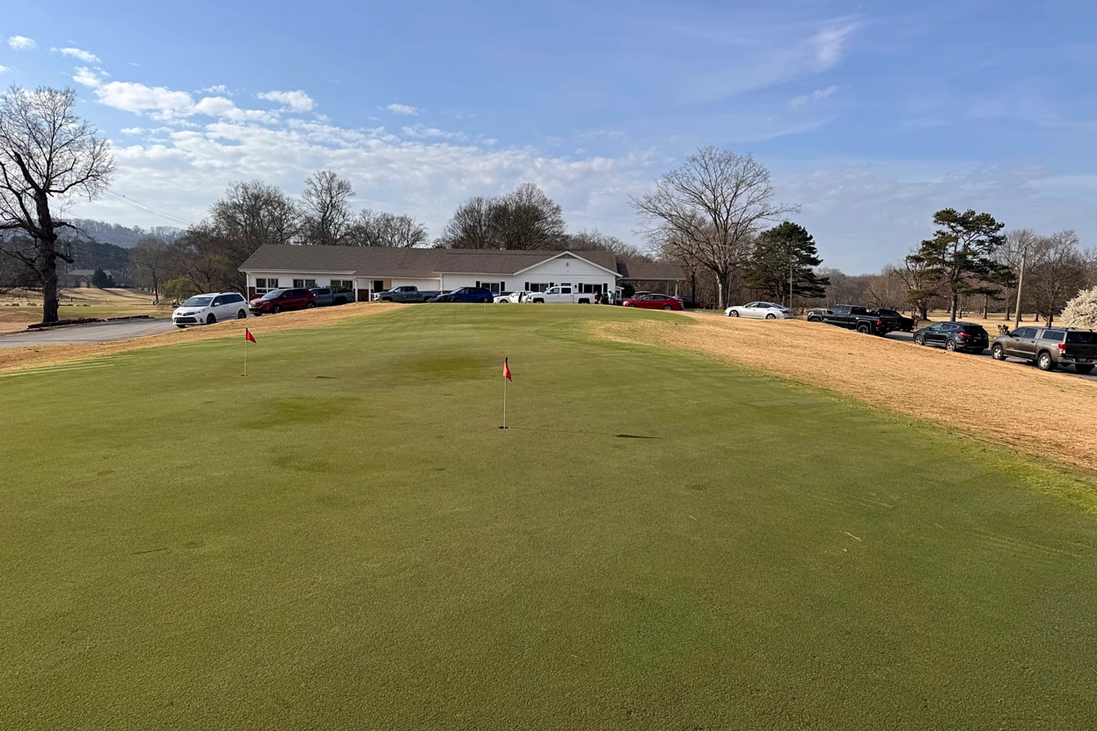 Clubhouse and practice green at Creeks Bend